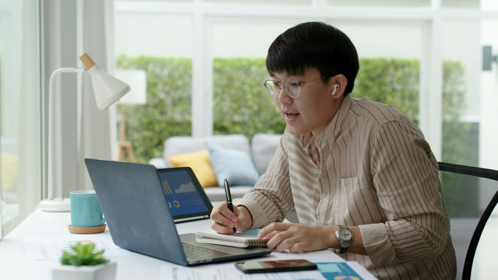 Asia people glasses chinese male busy talk discuss on desk at home in employee digital