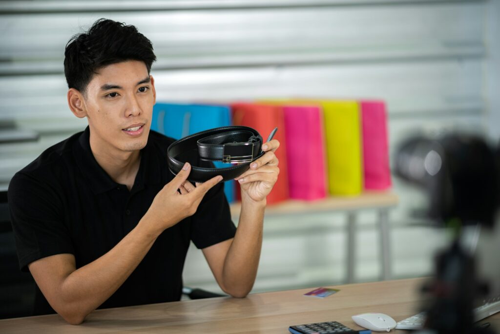 online sale social media marketing, young Asian man working with camera to live streaming to sale