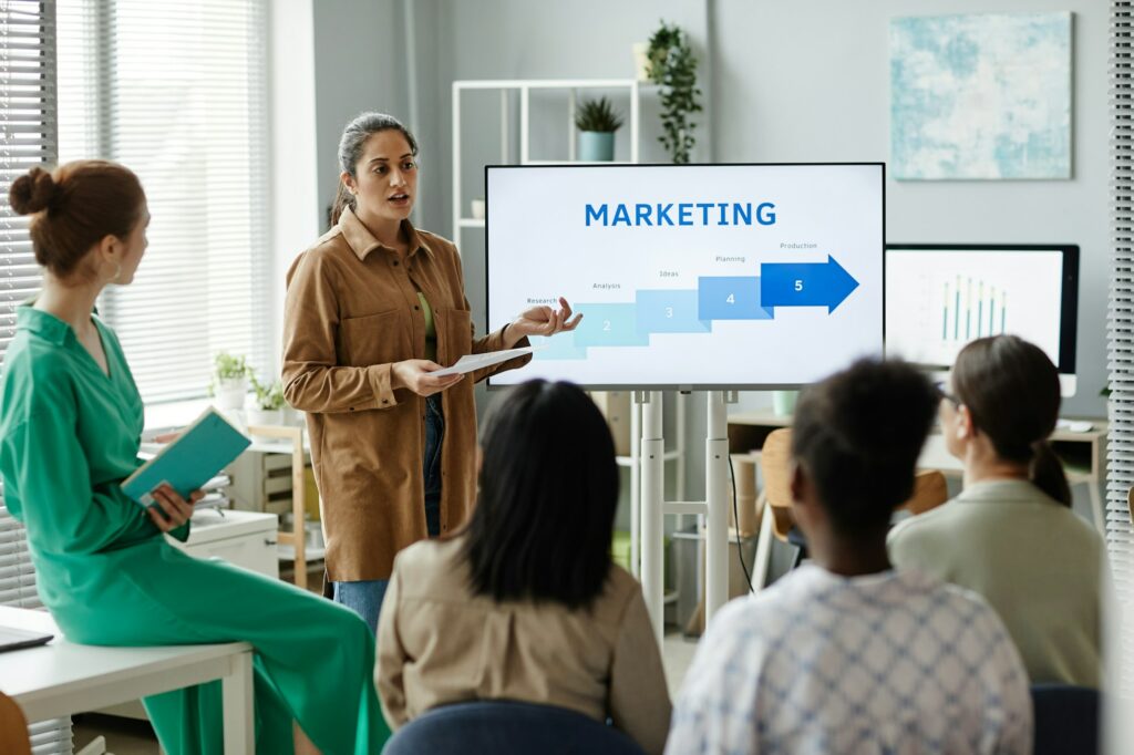 Woman presenting marketing strategy to colleagues