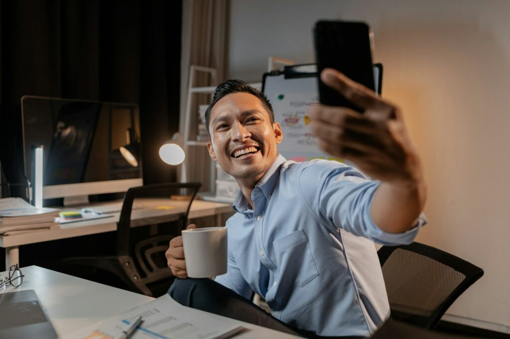 Asian businessman uses mobile phone in the office, he is a young and energetic company executive, ma