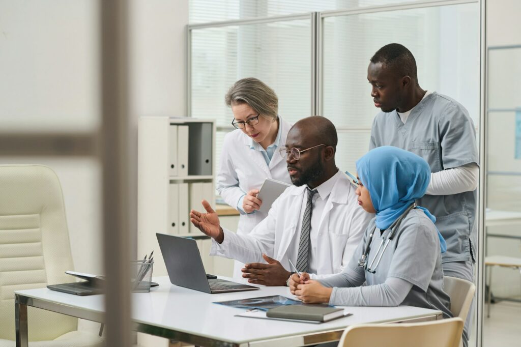 Doctors using laptop in their teamwork