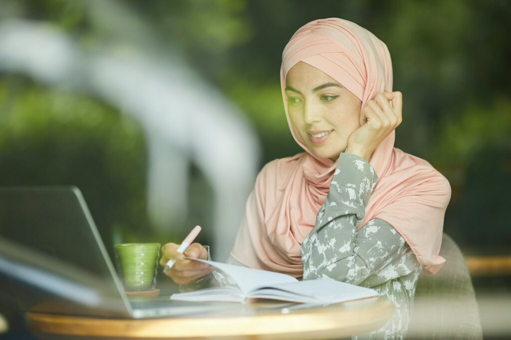 Woman in hijab watching webinar