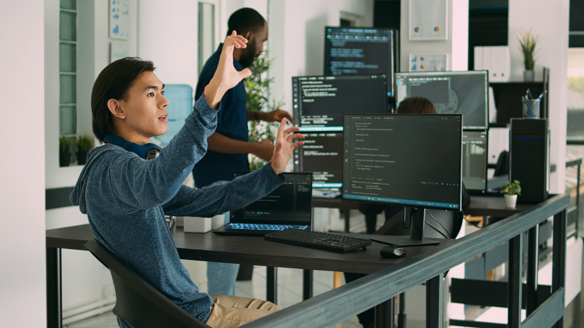 Asian web developer working with hologram and augmented reality