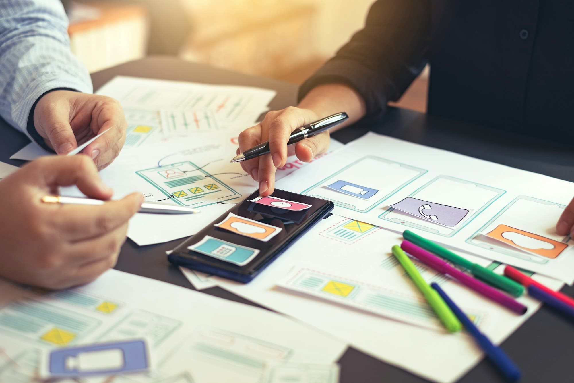 Team of design app on mobile phone, offering idea to develop application.