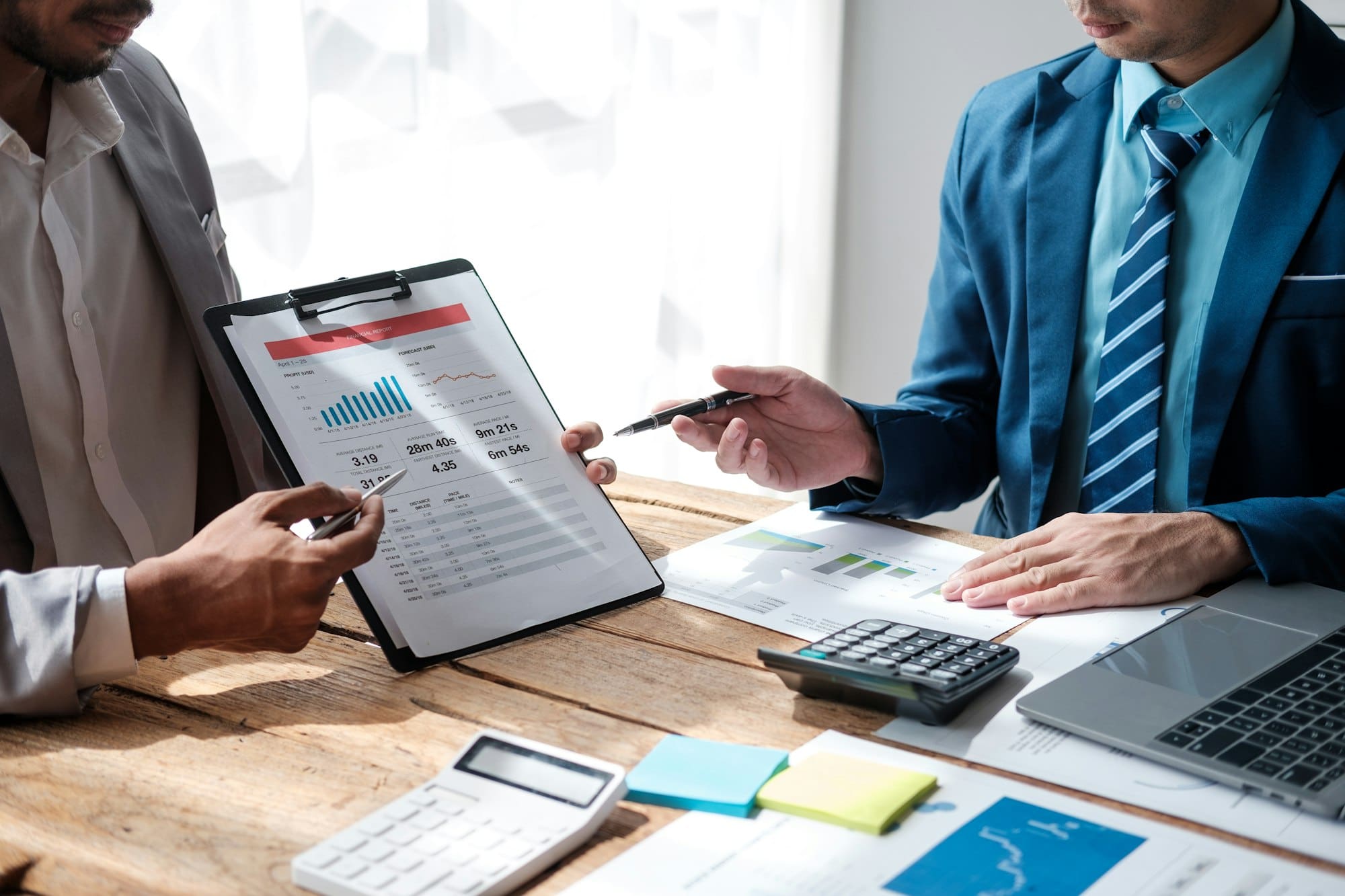 Team work process. Marketing strategy brainstorming. Paperwork and digital in office.