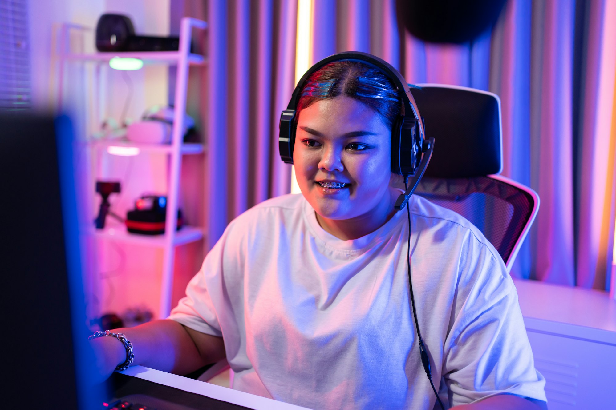 Asian beautiful Esport woman gamer play online video game on computer.