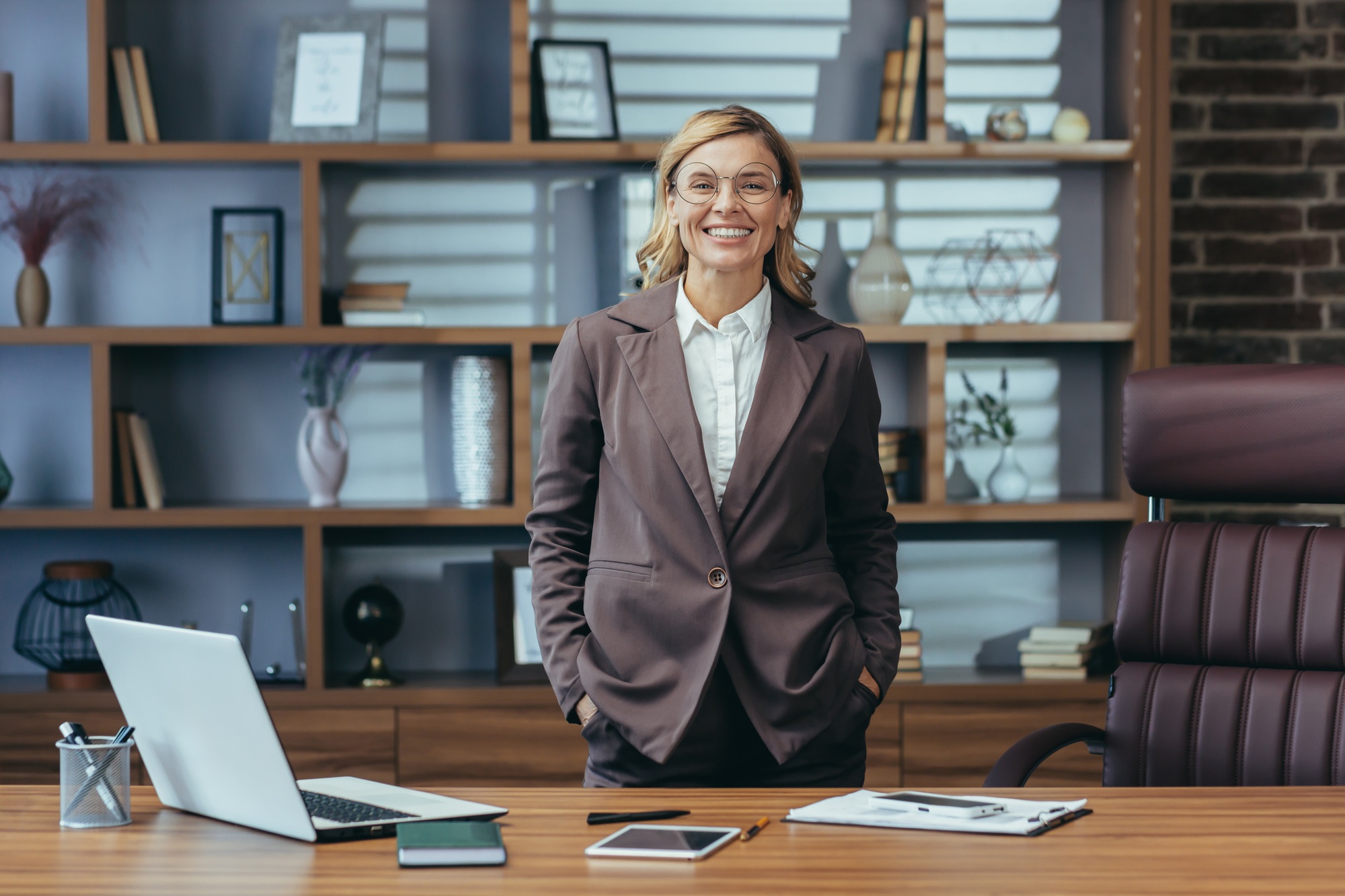 Portrait of a successful senior businesswoman and lawyer wearing a suit and standing in the office