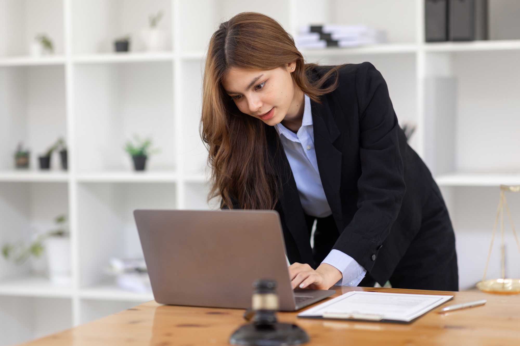 Attractive young lawyer in office Business woman and lawyers discussing contract papers with brass