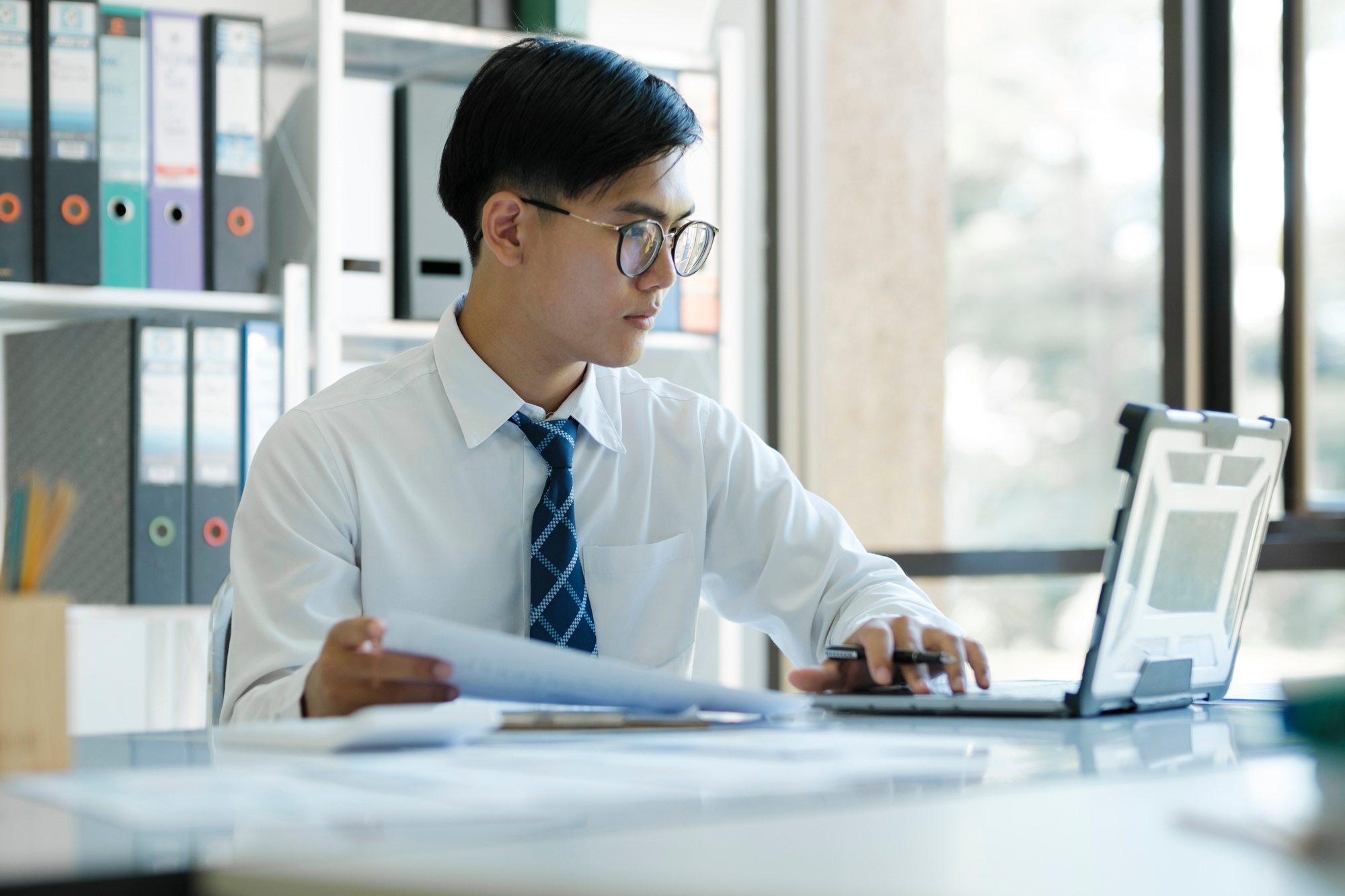Businessman is analyzing online marketing on laptop computer