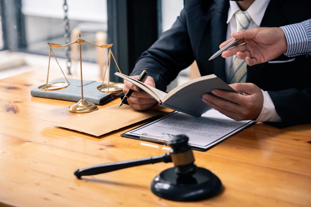 Business lawyer working about legal legislation in courtroom to help their customer justice and law