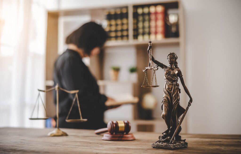 Lady Justice Holding Scales of Law in a Courtroom - Symbolizing Equality, Fairness