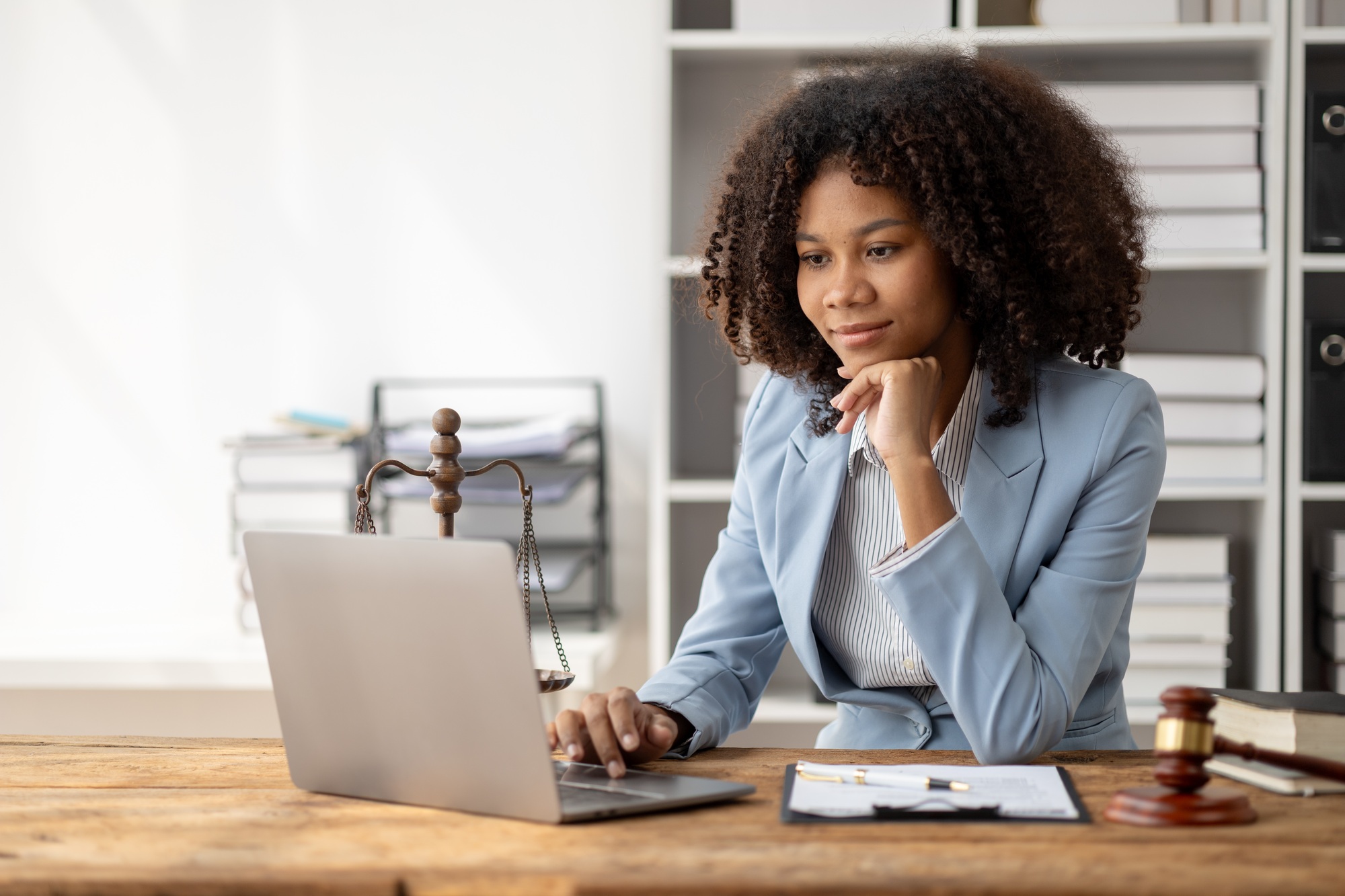 American woman is legal litigation attorney, Female lawyer is in a law firm drafting contracts and r