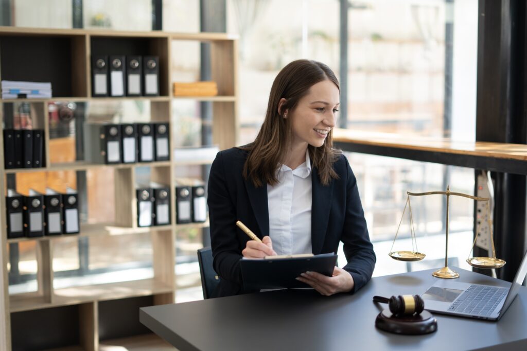 Woman lawyer working on a laptop. Legal law, advice and justice concept.