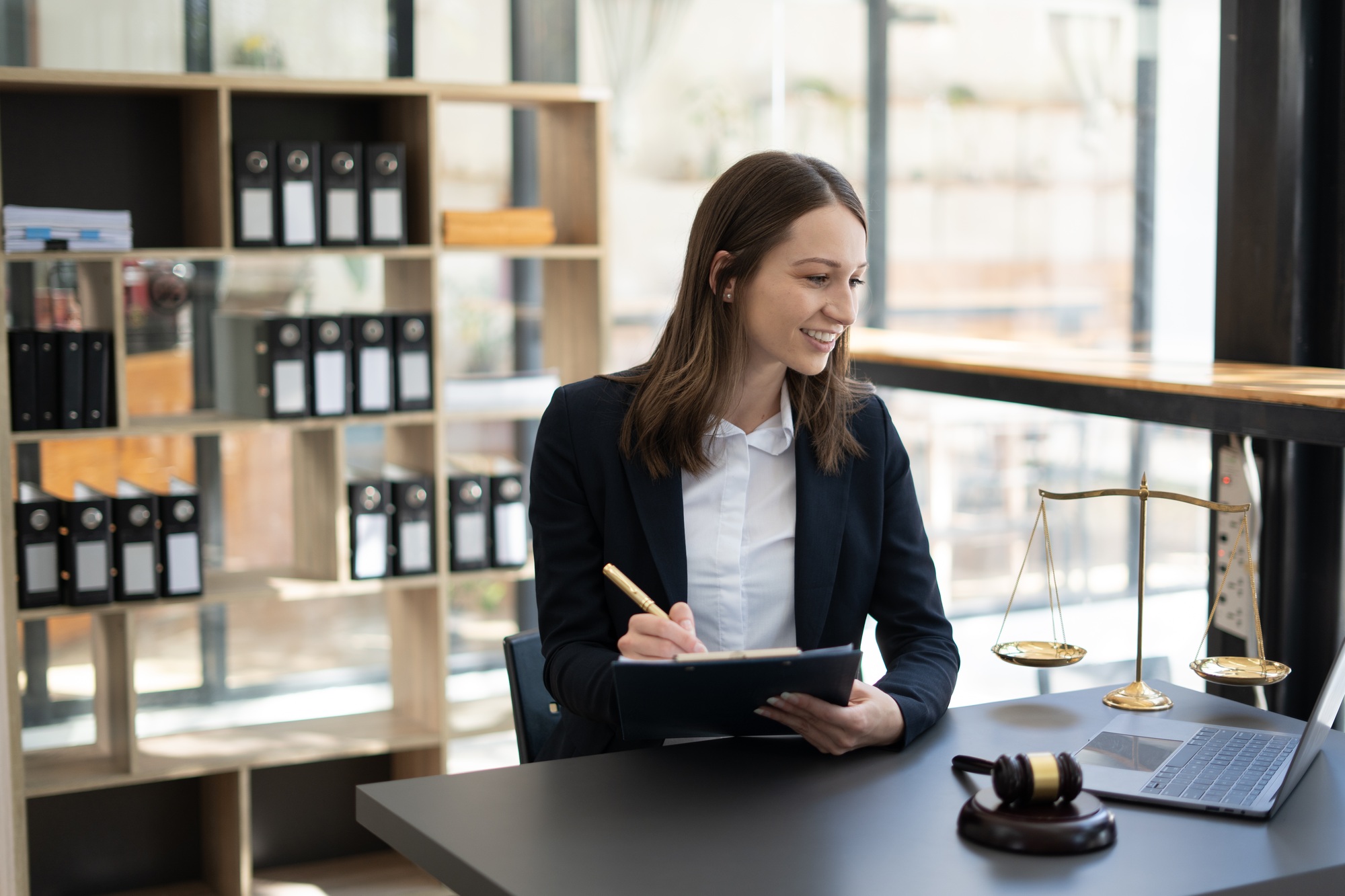 Woman lawyer working on a laptop. Legal law, advice and justice concept.