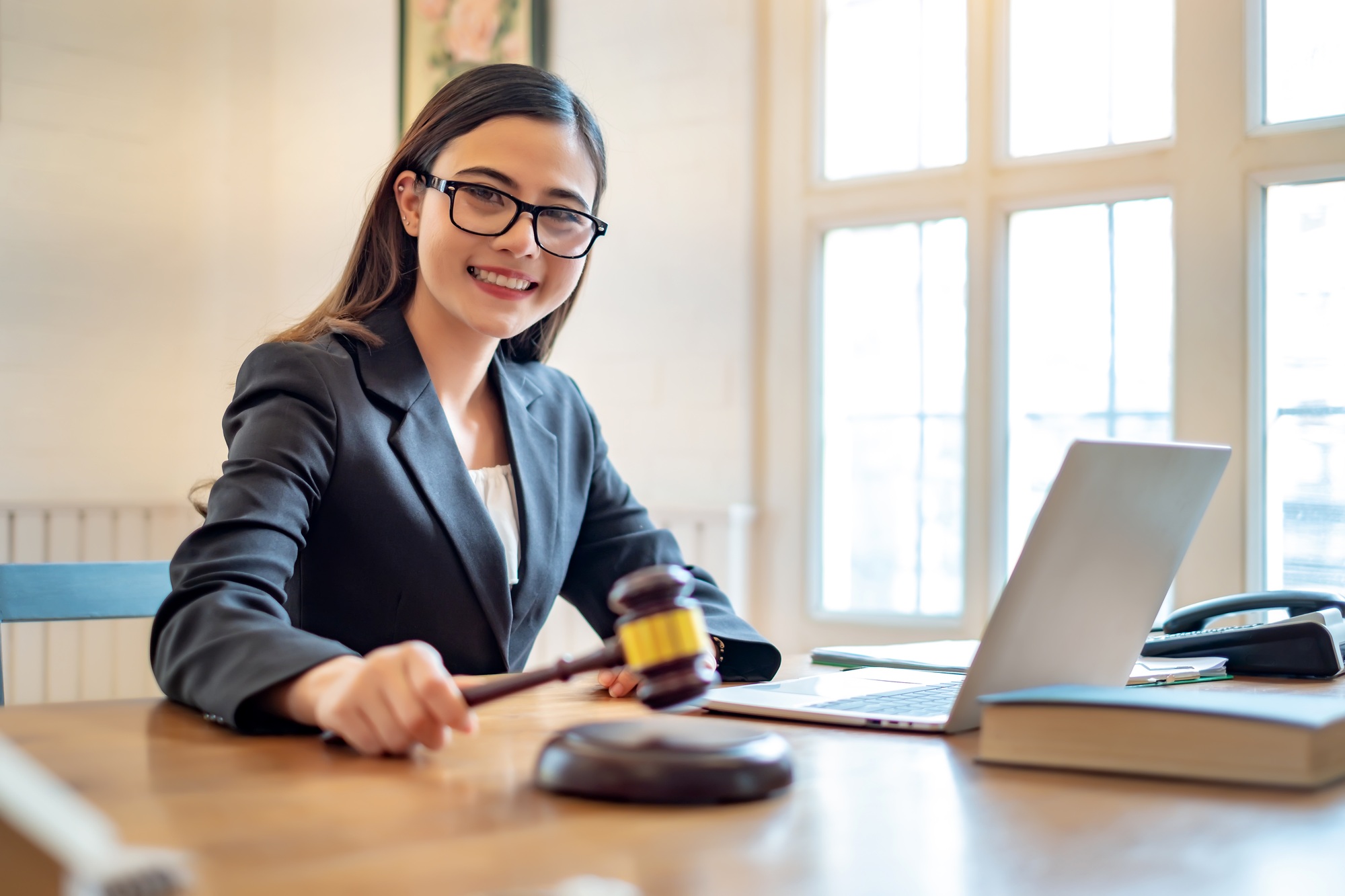Asian lawyer woman working with a laptop computer in a law office. Legal and legal service concept.